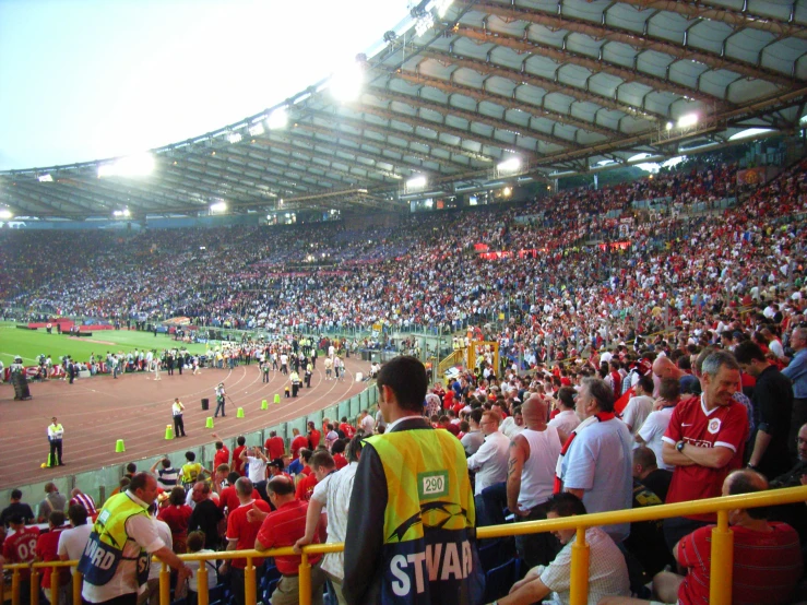 a large stadium filled with fans on the sidelines