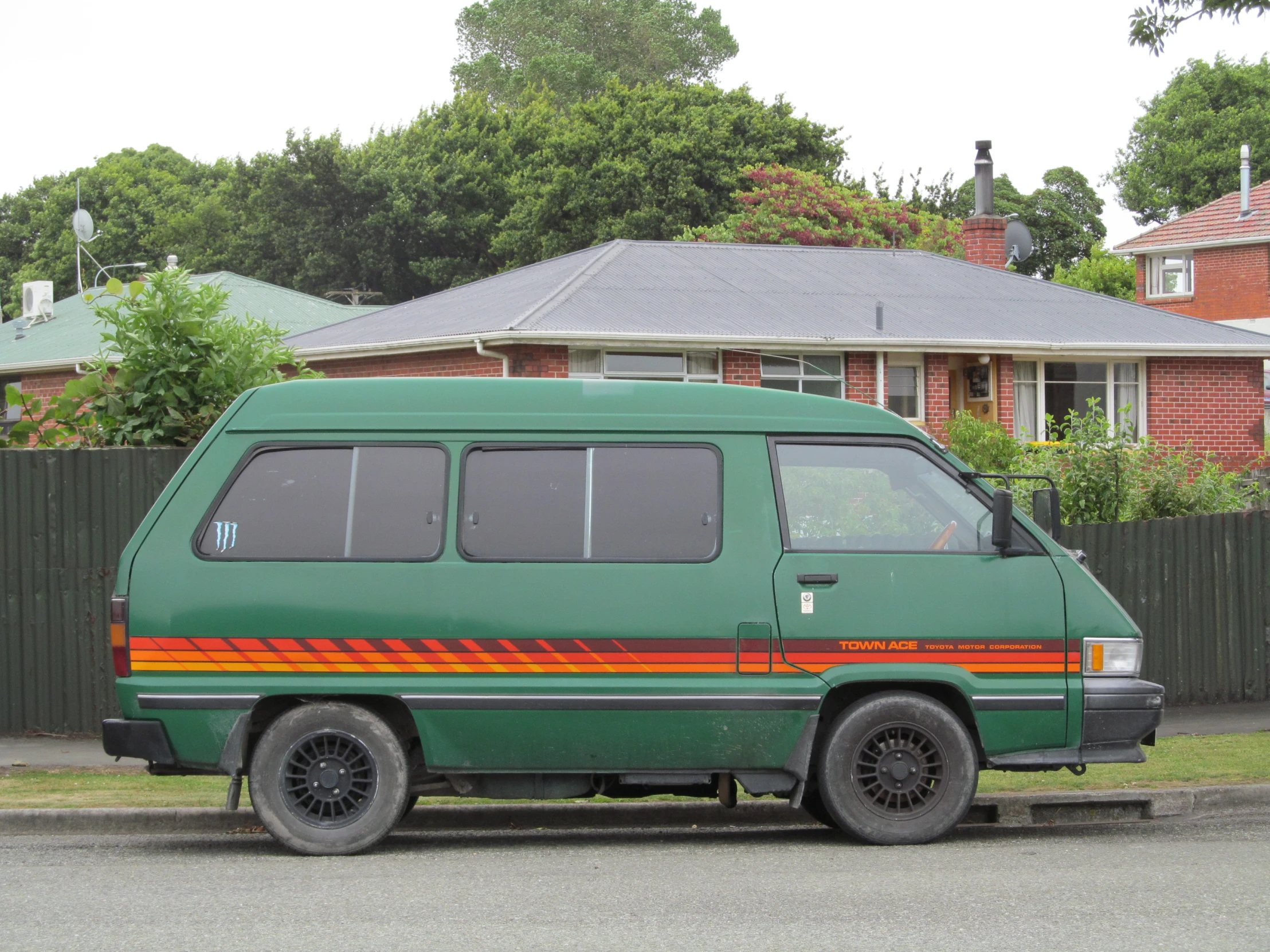 a green van parked in front of a house