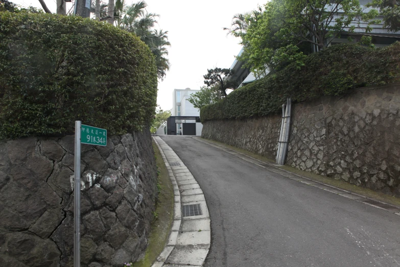 a street sign is attached to the side of a wall