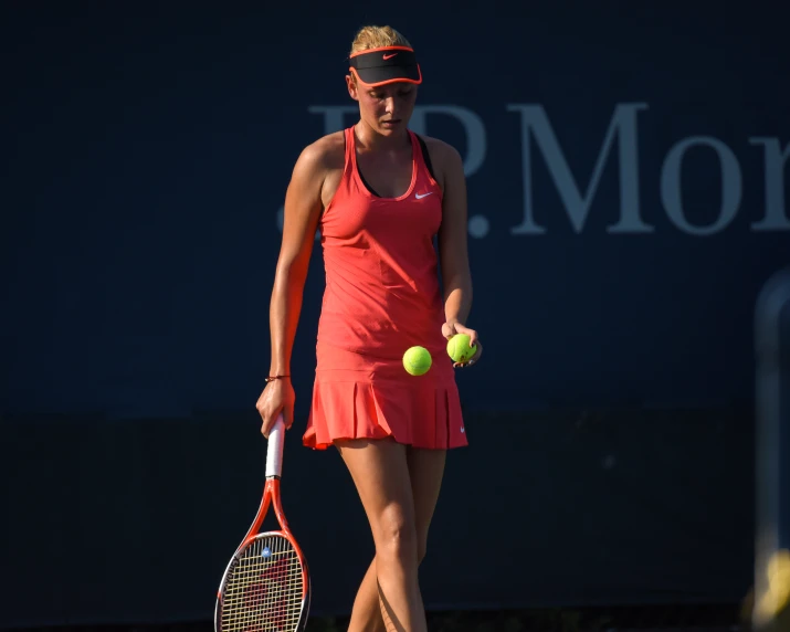 the woman in a tennis dress is playing tennis