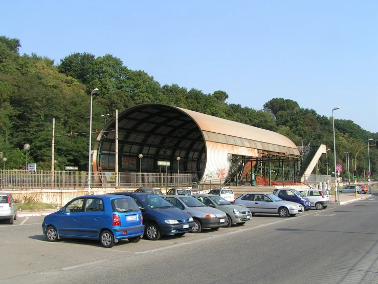 cars are parked outside in front of a large building