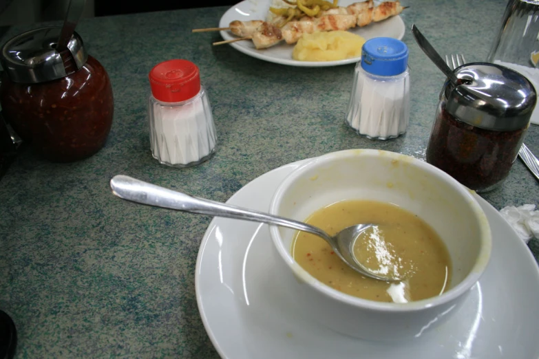 there is a white bowl and some food on the table