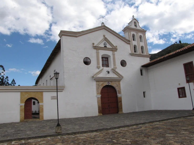 a white church with a clock on the tower