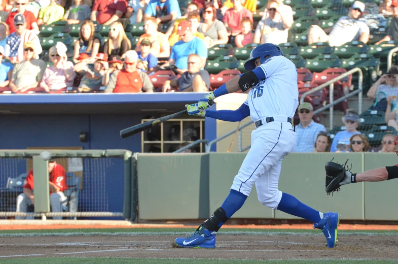 the baseball player in the blue uniform is swinging at a ball