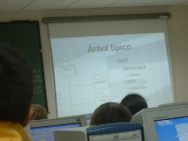 a large screen with some writing on it in a classroom