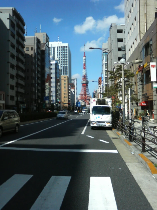 a bus driving down a street next to tall buildings