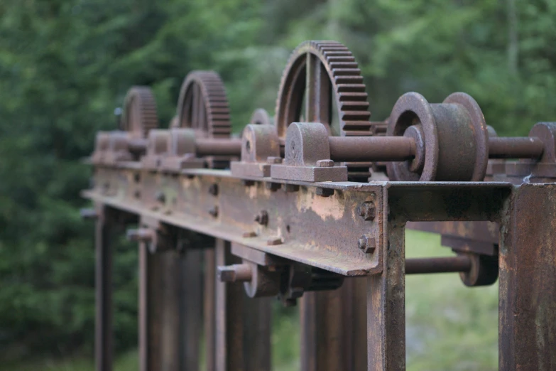 there is an old rusted, rusty metal device hanging from the wall