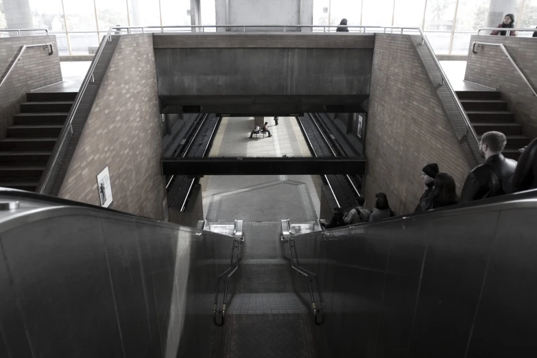 several people sitting and walking in an underpass