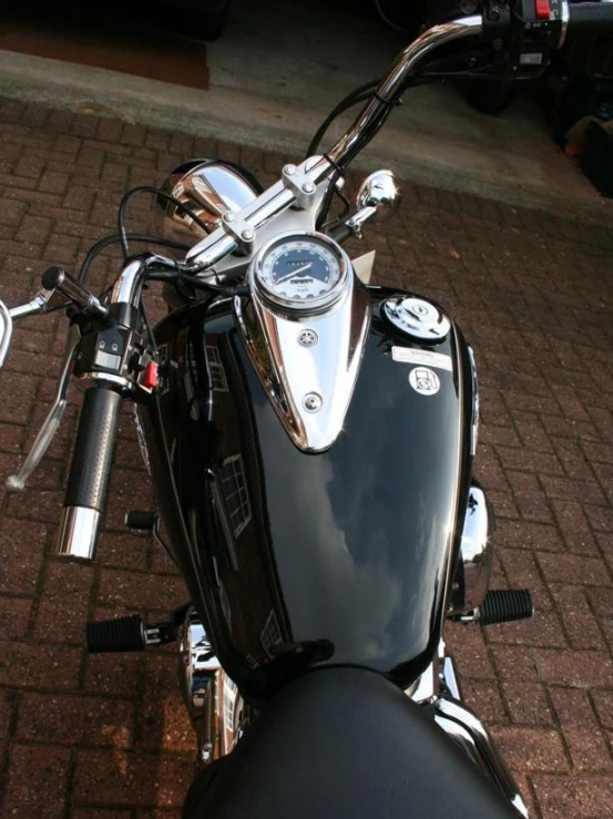 a black motorcycle with a clock mounted to it's rear end