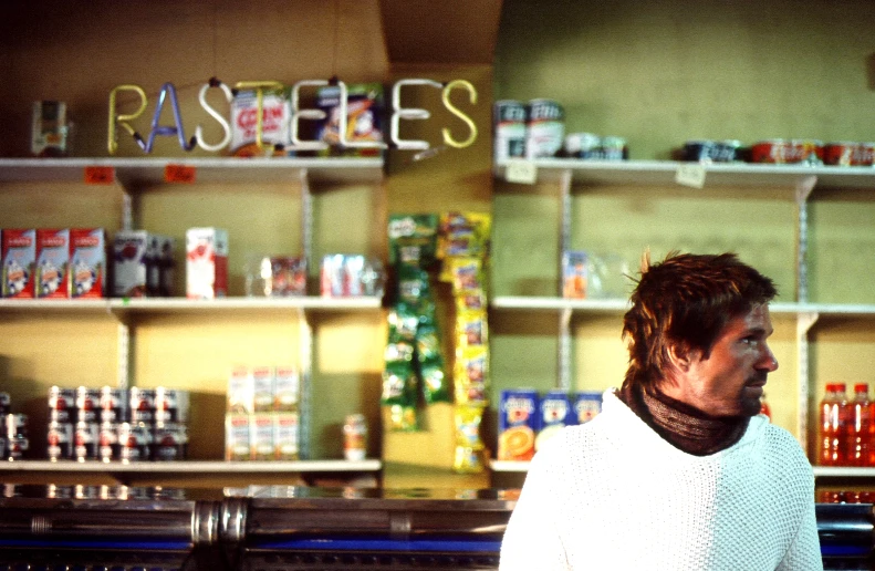 a person standing near a shelf with food in it