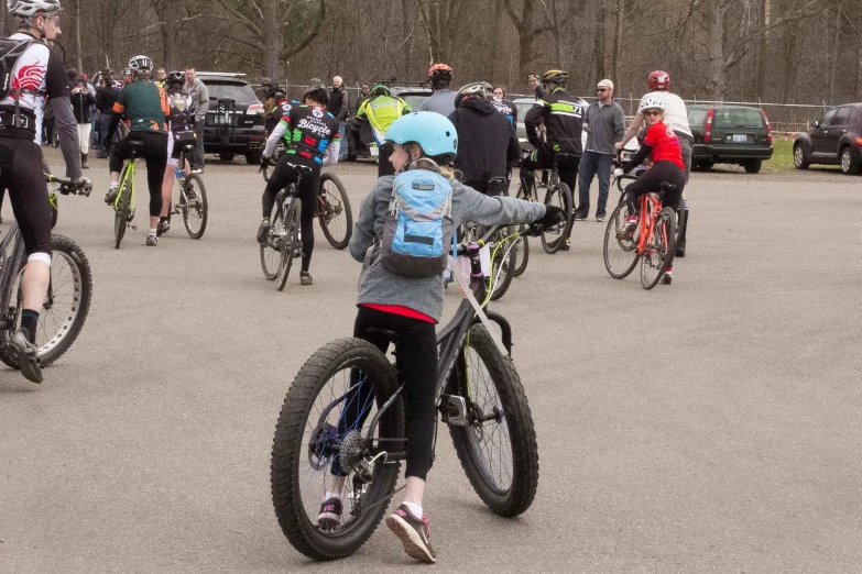 a  standing in front of a bunch of bikes