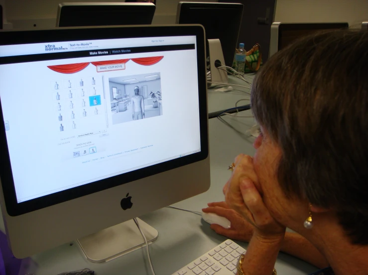 a woman looking at an old computer screen