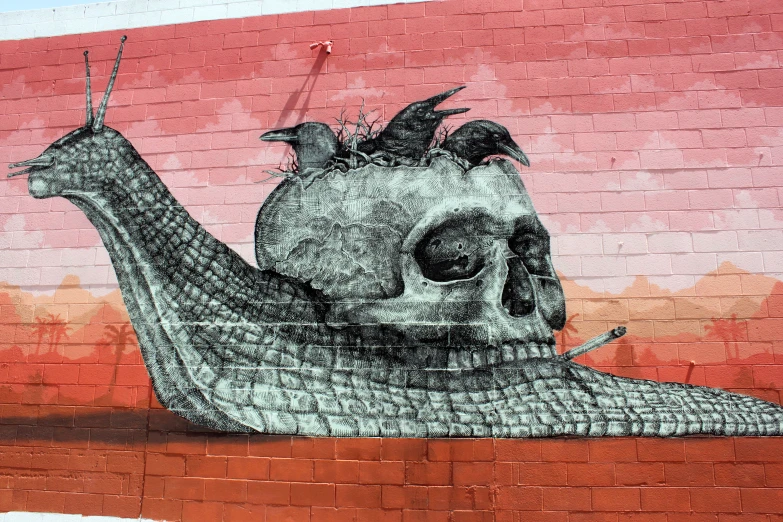 mural painted on the side of a brick wall depicting a human being with birds