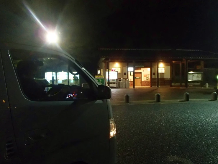 a car is parked in front of a motel at night