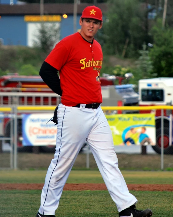 a baseball player wearing red and white on a field