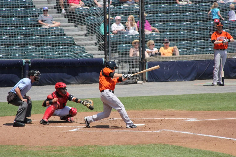 a batter swings at the ball during a baseball game