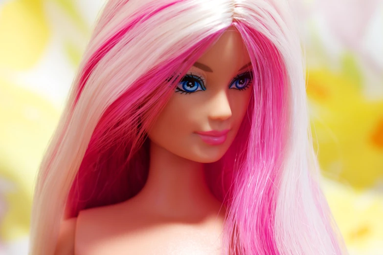 an extreme close up s of a barbie doll with pink hair