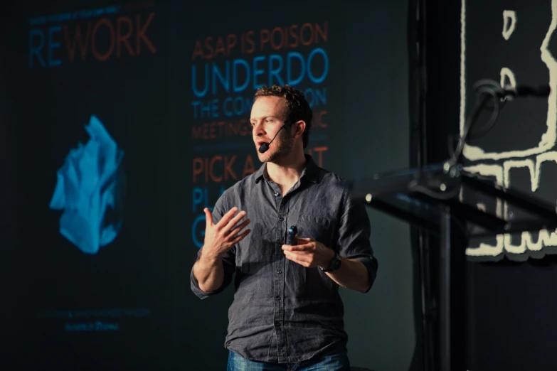 a man giving a presentation with his hands open