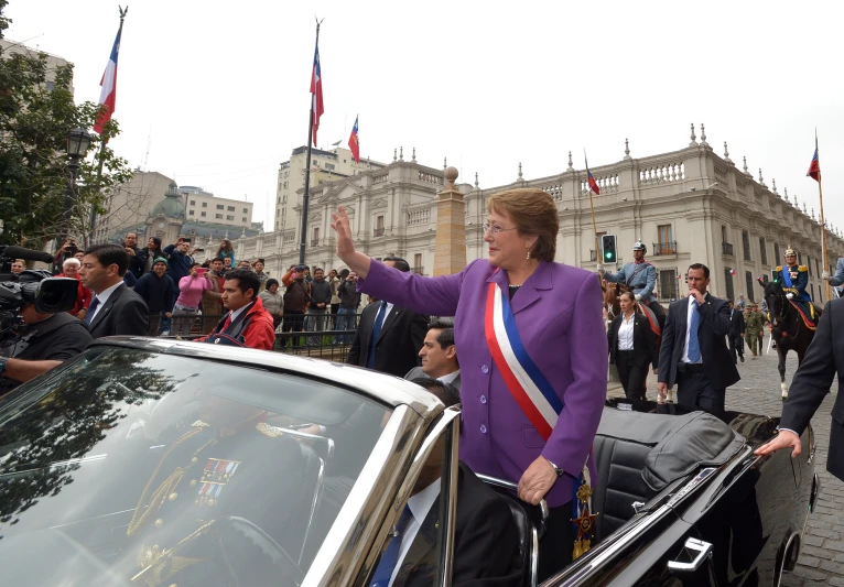 woman speaking in front of a car at an outdoor event