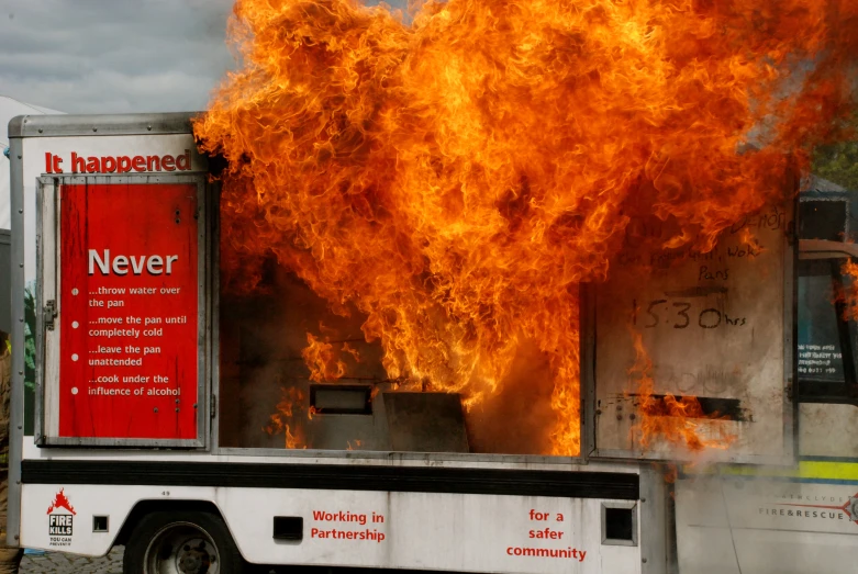 the large truck has huge red flames coming from it's side