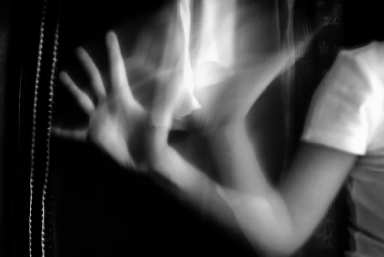 a close up of a woman holding her hands behind her back