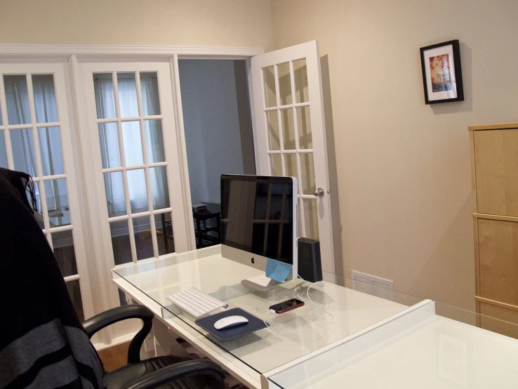 a desk with a computer monitor and keyboard