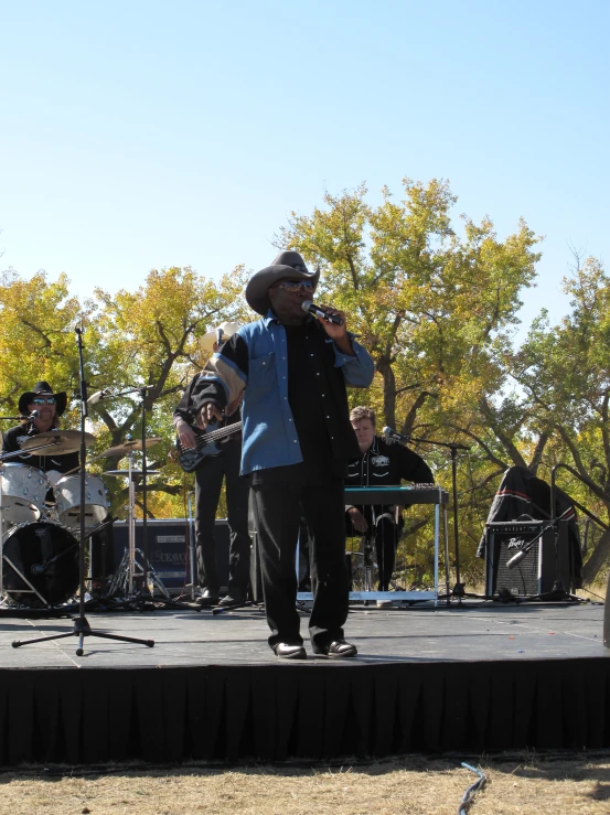 a band performing on stage with people watching