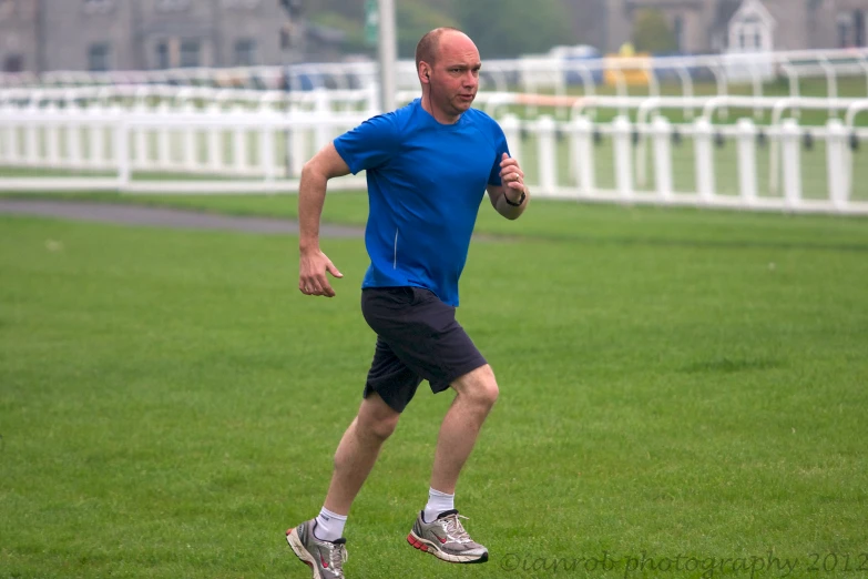 a man in a blue shirt is playing soccer