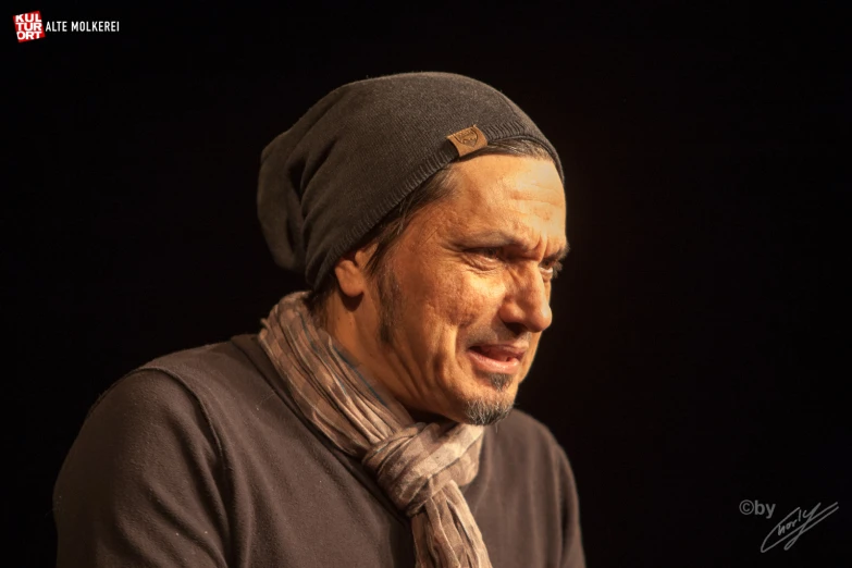 a man wearing a hat and a scarf on his head