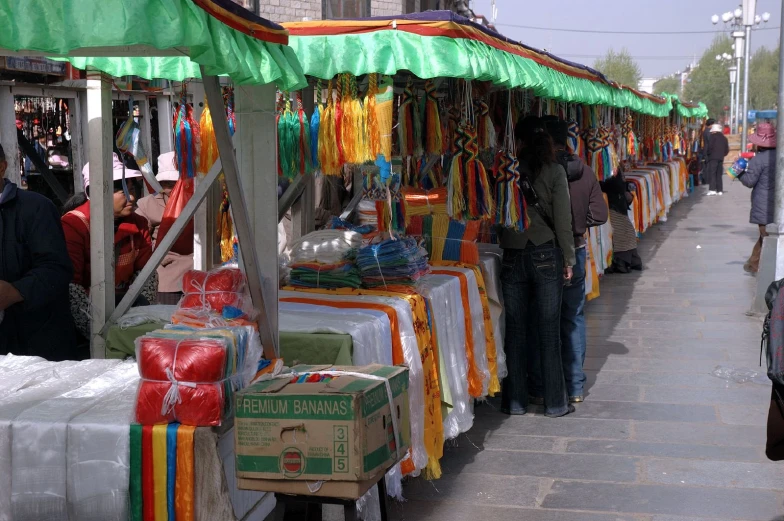 a number of people standing near different vendors