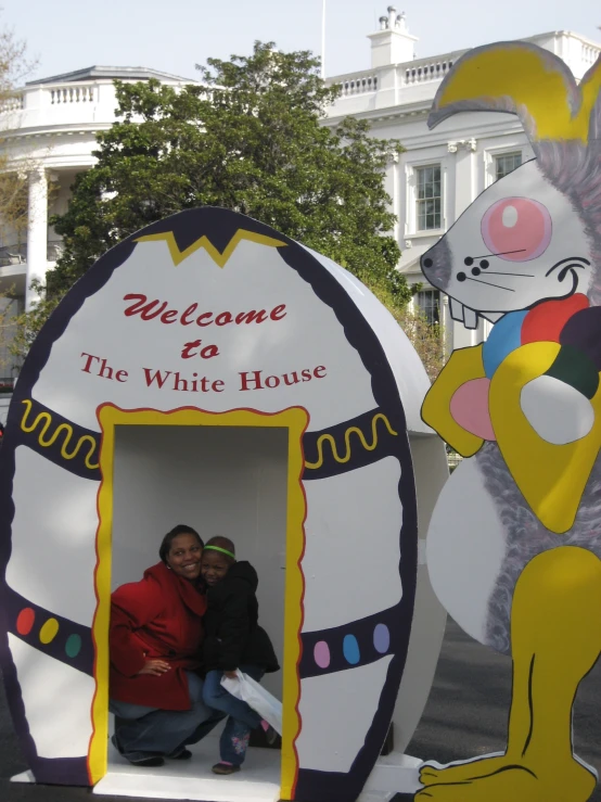 a couple pose for the camera in their entrance decoration