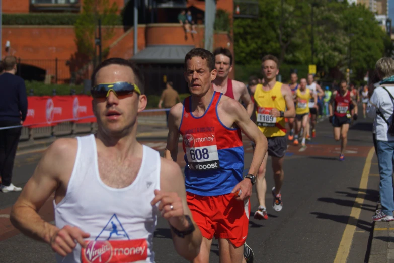 a group of people are running in a marathon