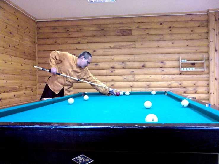 two men in front of a pool table with balls