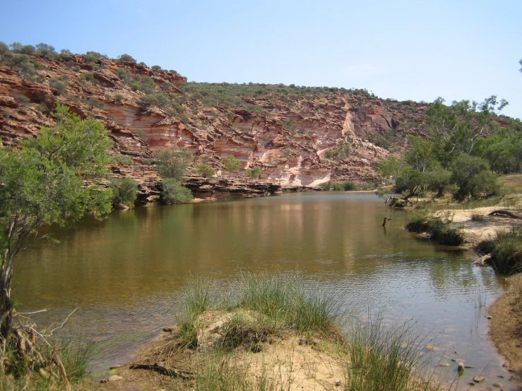 the small pond is very wide and empty of people