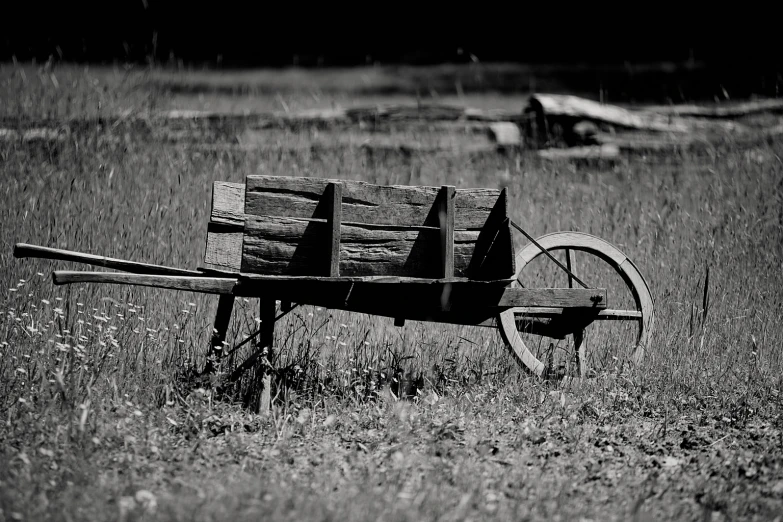 a black and white image of an old wagon