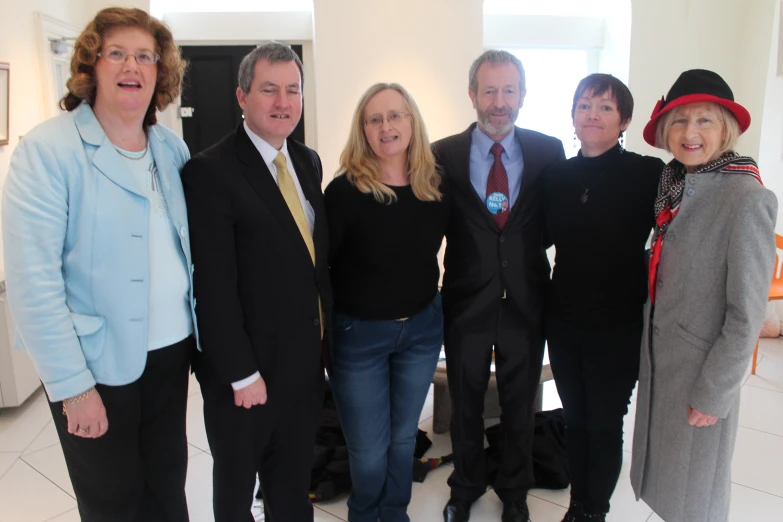 four people are standing in a room together