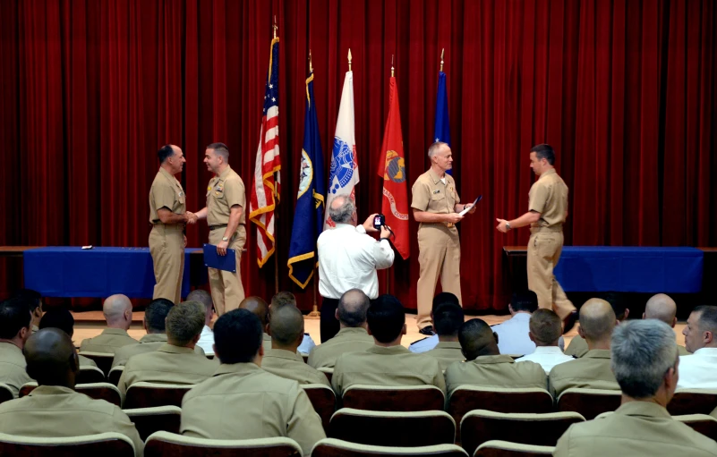 two military officers being presented to others