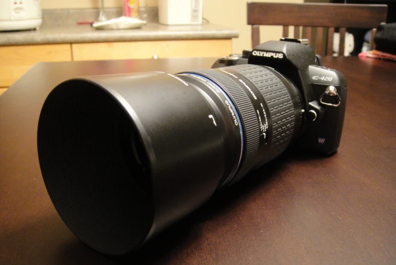 an empty camera on a wooden table in a kitchen