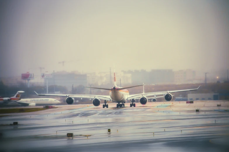 a plane is sitting on the runway during the day