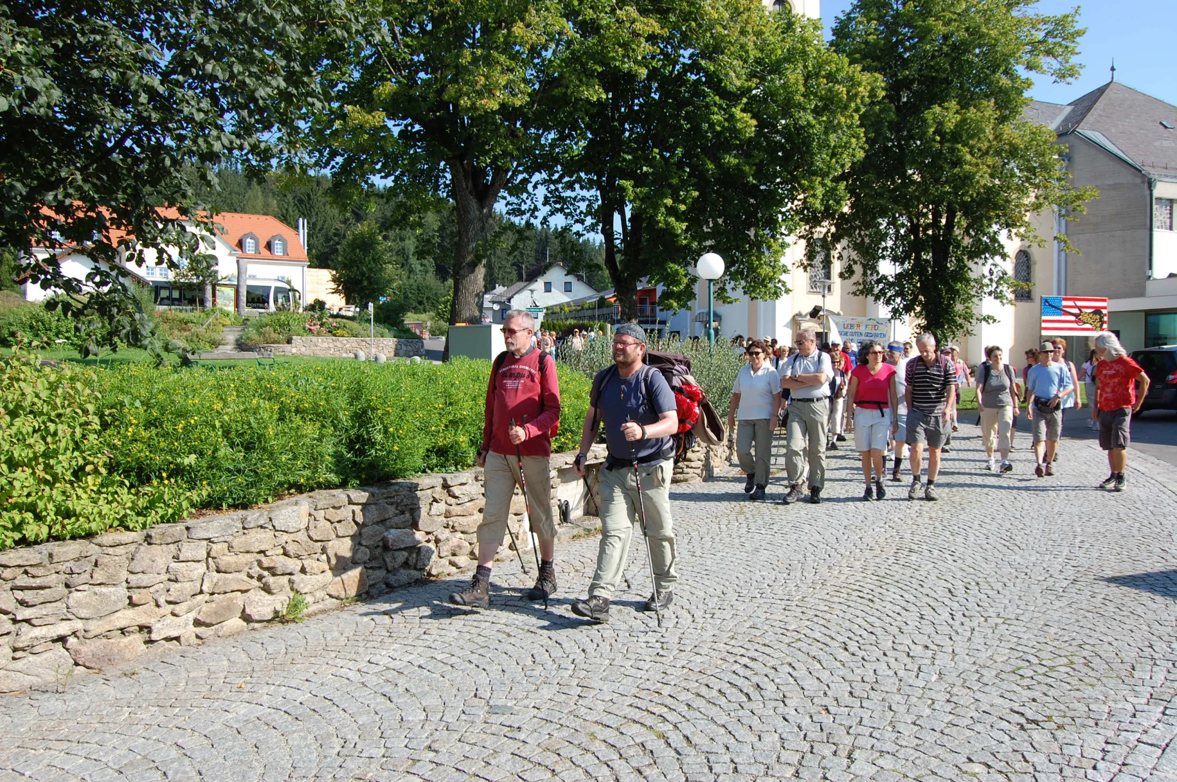 a group of young people standing around on the side of a road