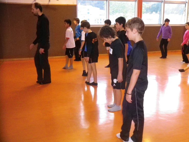 a group of young s standing in a gymnasium