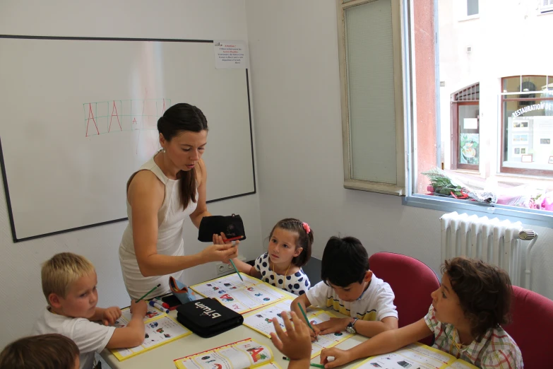 some young children and their teacher in class