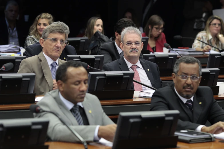 men in suits and ties in a conference room