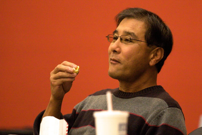 an image of a man eating food with cupcakes