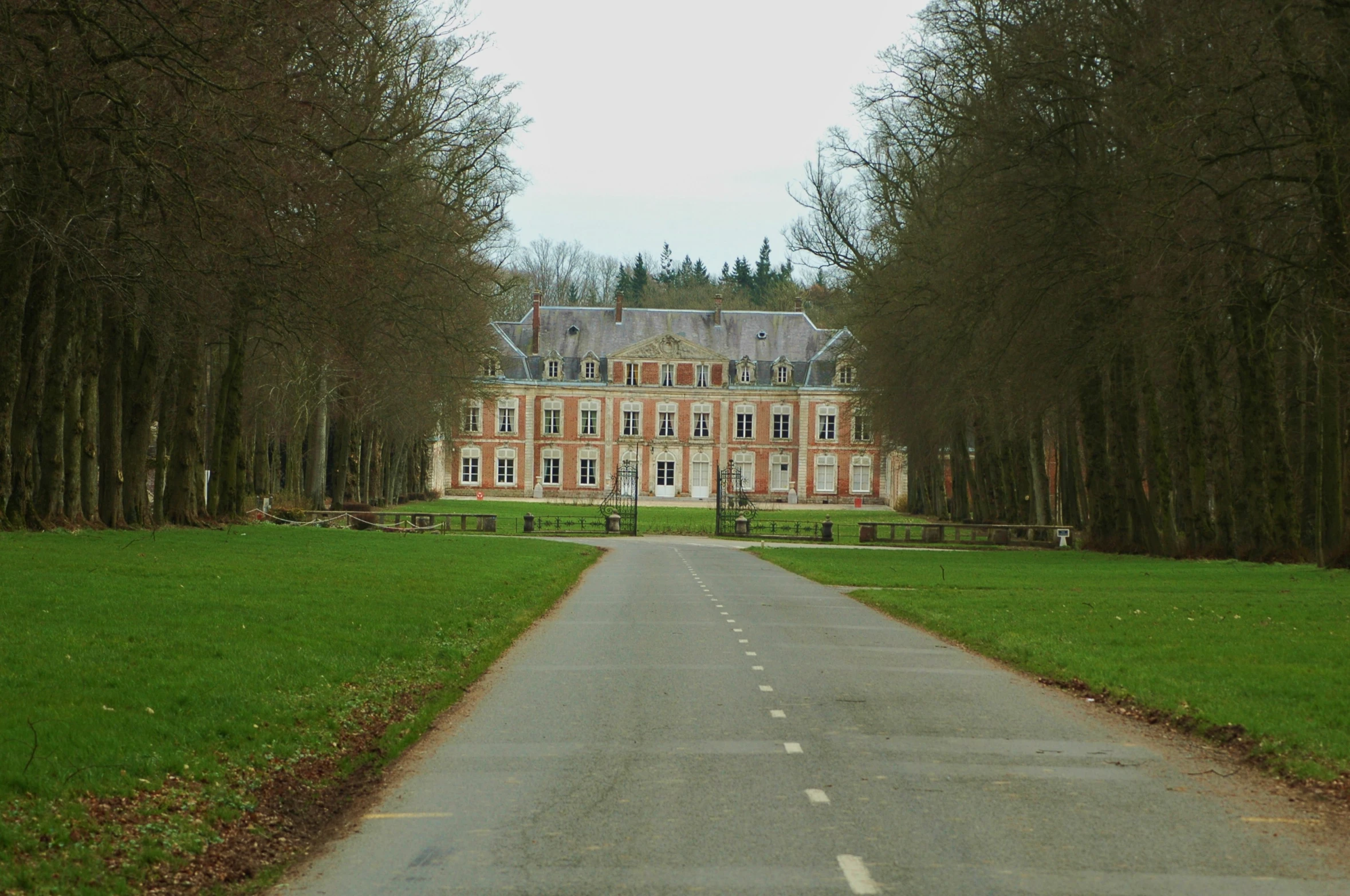 a large stone building sitting next to green trees