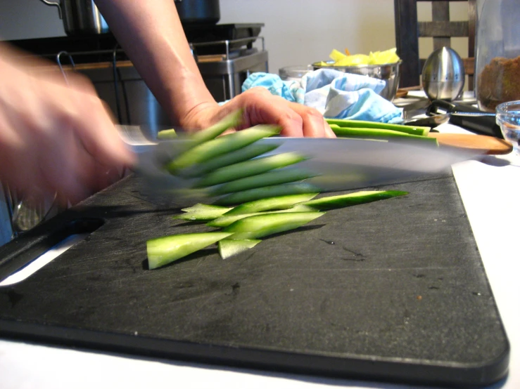 a person that is  vegetables on a table