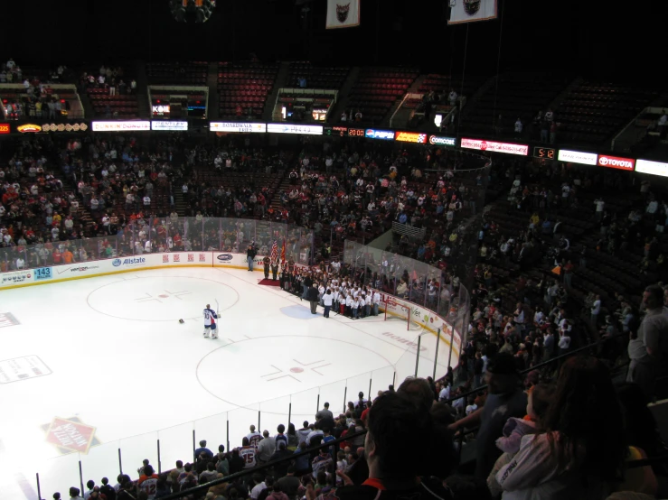 an outdoor arena with a hockey game in progress