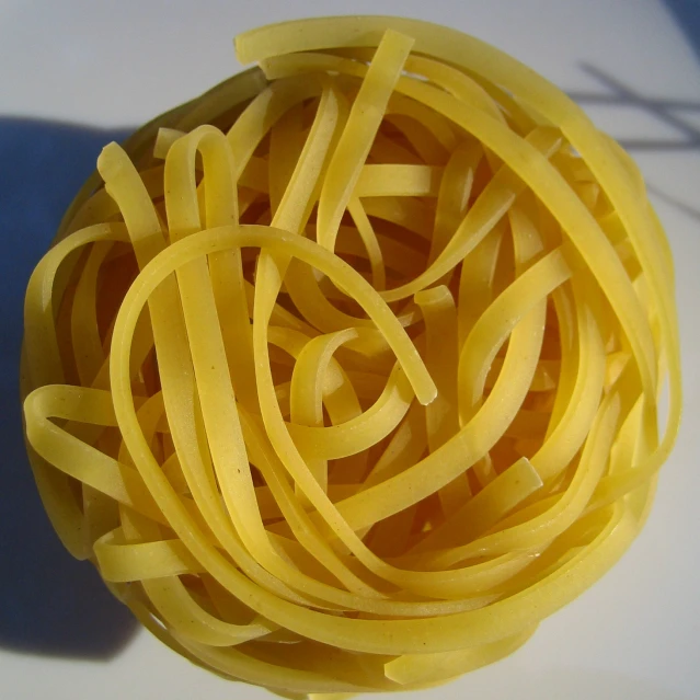 close up of an uncooked round pasta pasta is on a table