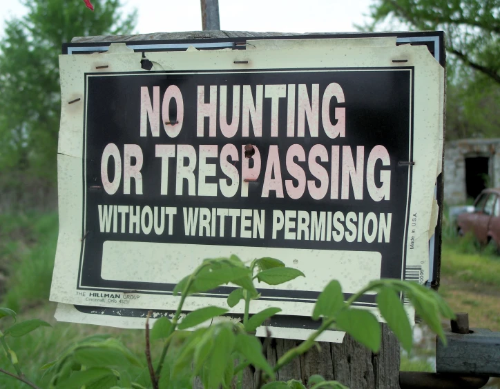 a sign that has been put in the bushes