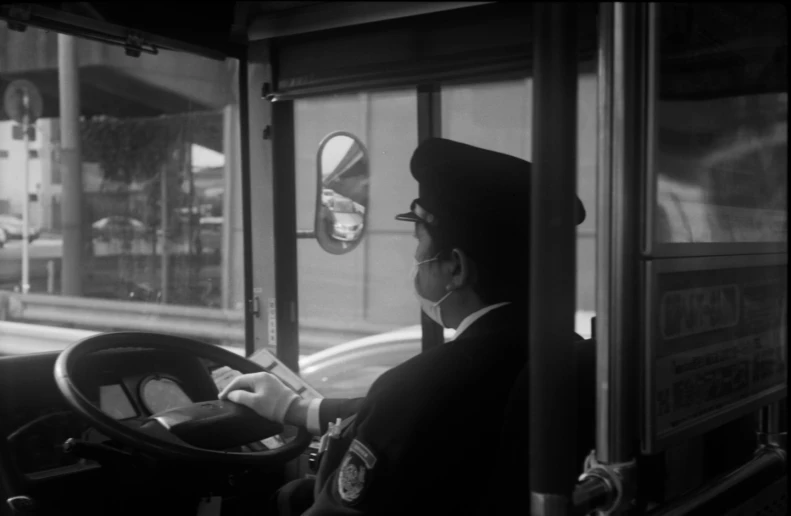 the city policeman is driving a city bus